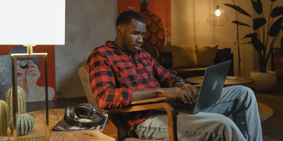 Man using laptop to get car finance