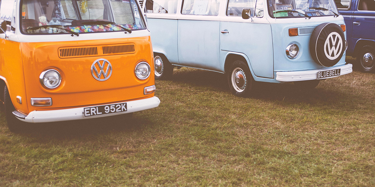 2 vw camper vans parked in a field