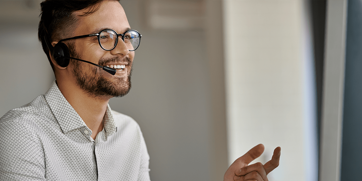 Man wearing a headset completing customer finance checks