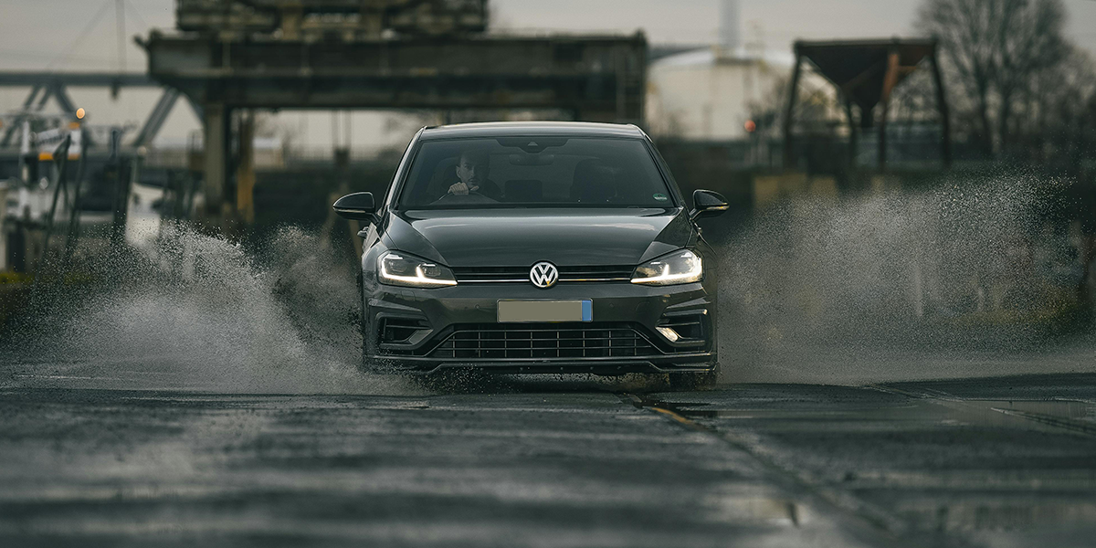 Grey car driving in the rain