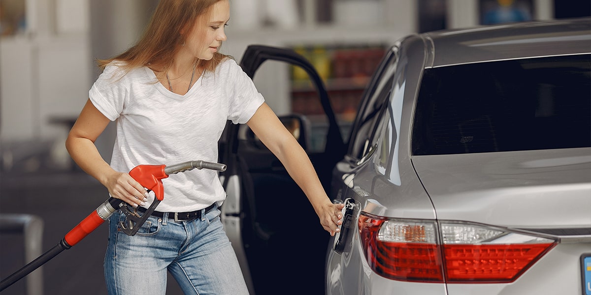Woman filling car with premium diesel