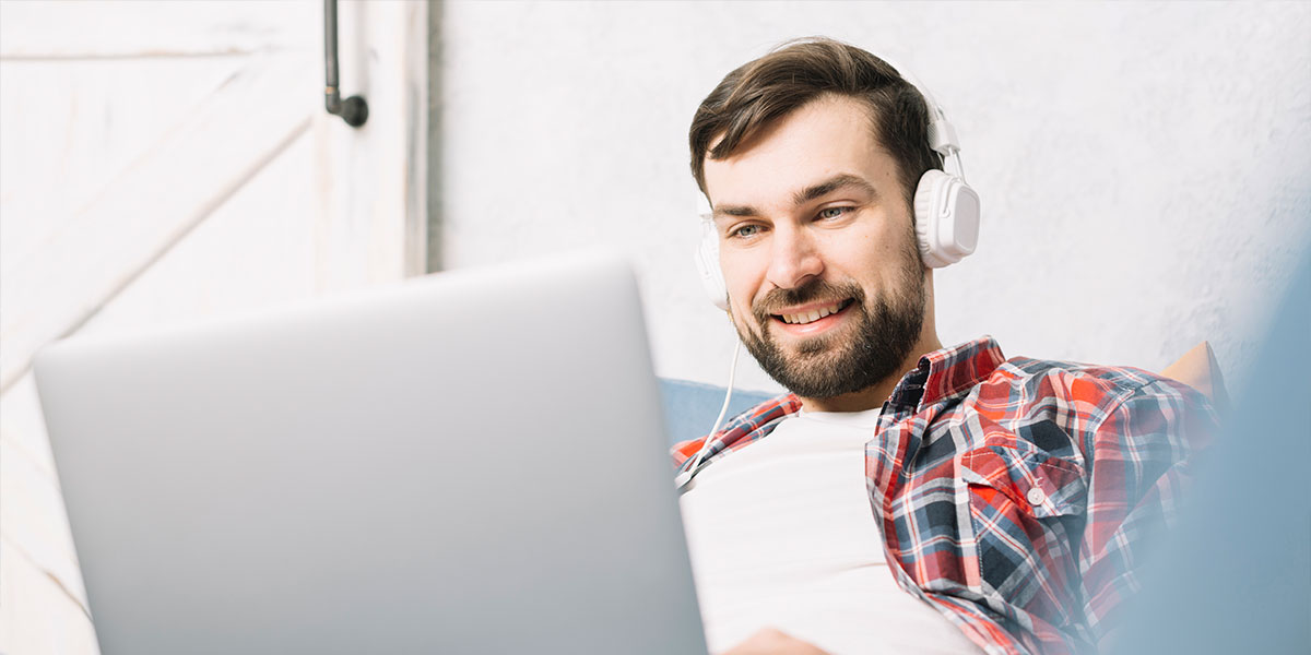 Man with headphones getting a car finance quote online